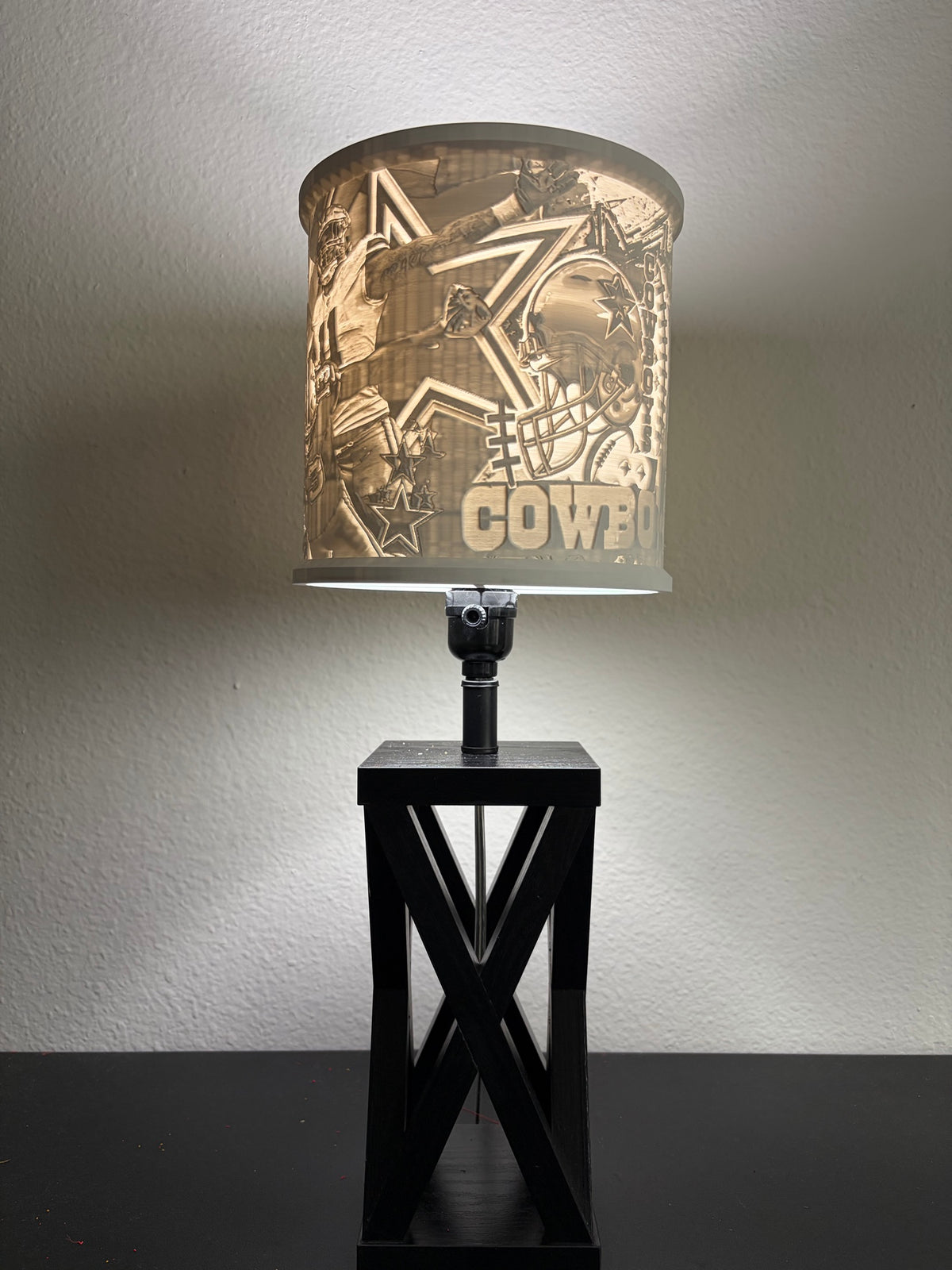 Illuminated Dallas Cowboy lampshade showing football players, a helmet and star collage