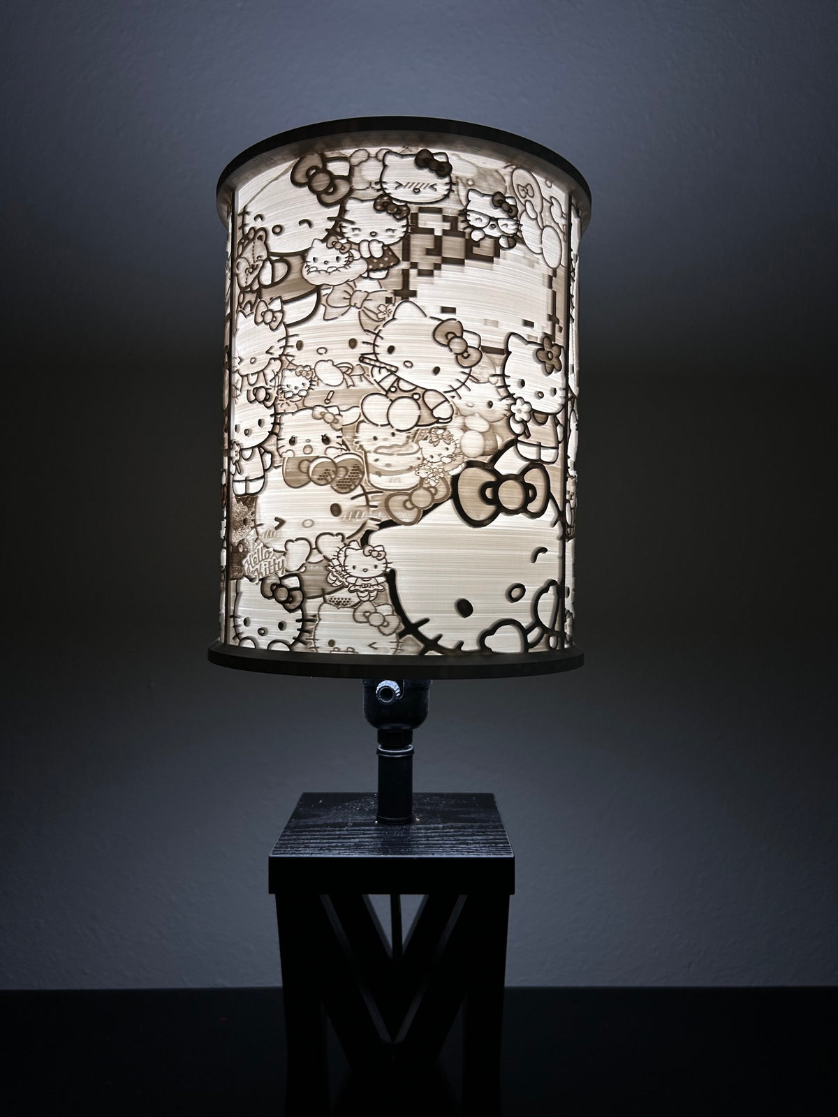 Opposite side of Hello Kitty-inspired lampshade showing varied character portraits and bow details